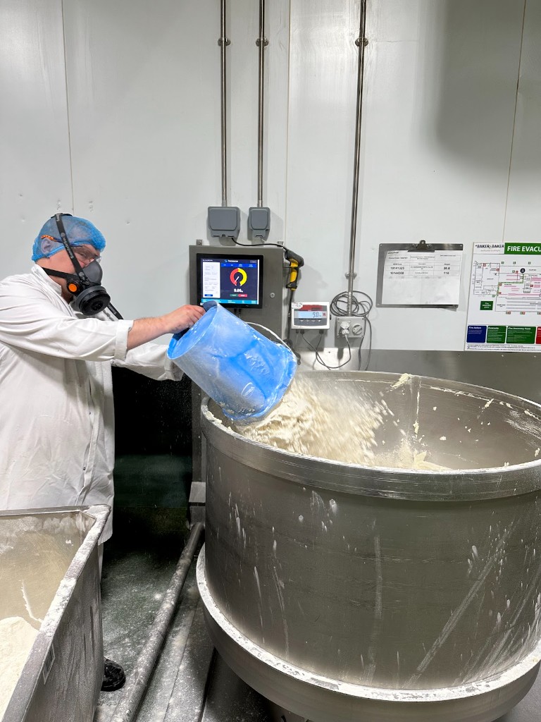 Operator using TraceSense digital weighing for recipe batch control on the production line